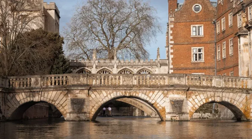 A stone bridge over the river Cam, as viewed from the river.