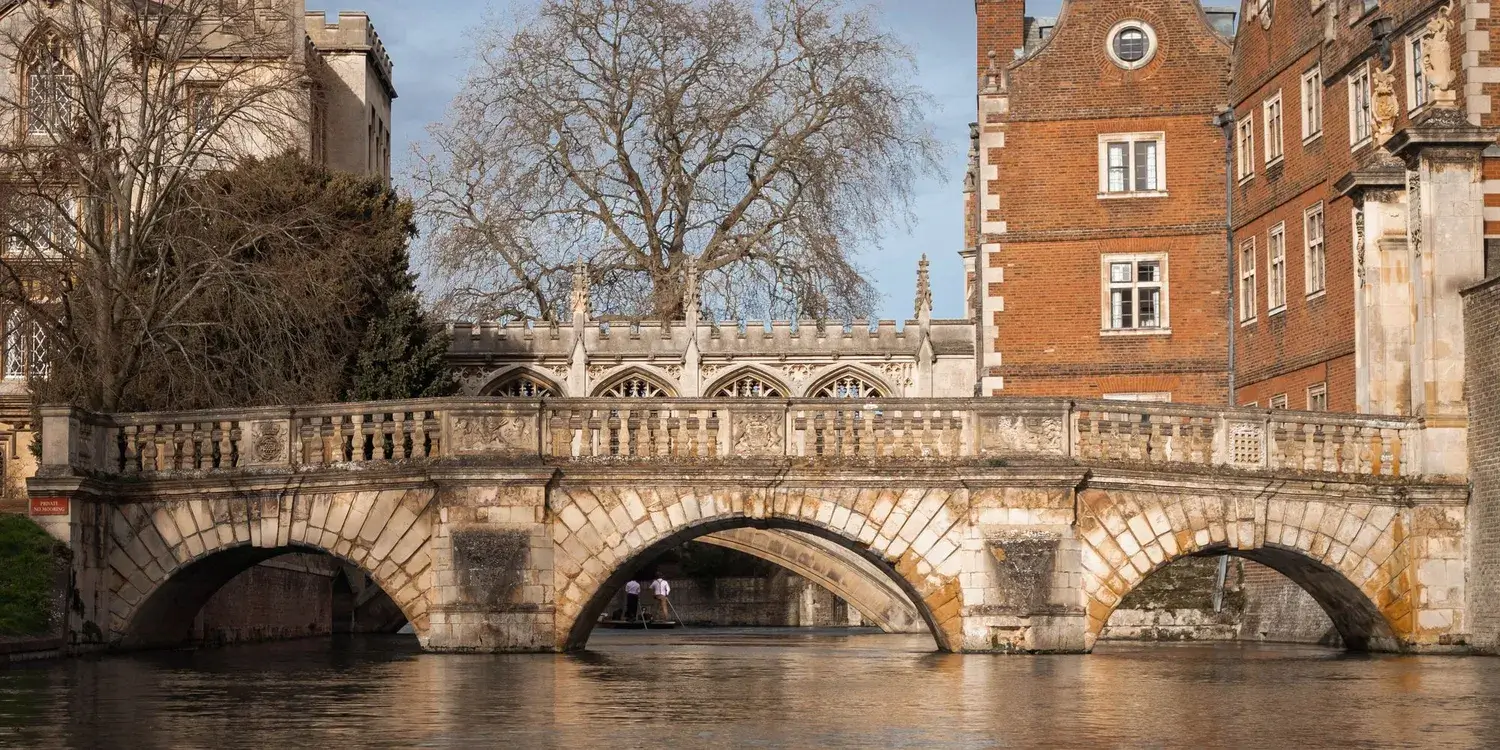 A stone bridge over the river Cam, as viewed from the river.