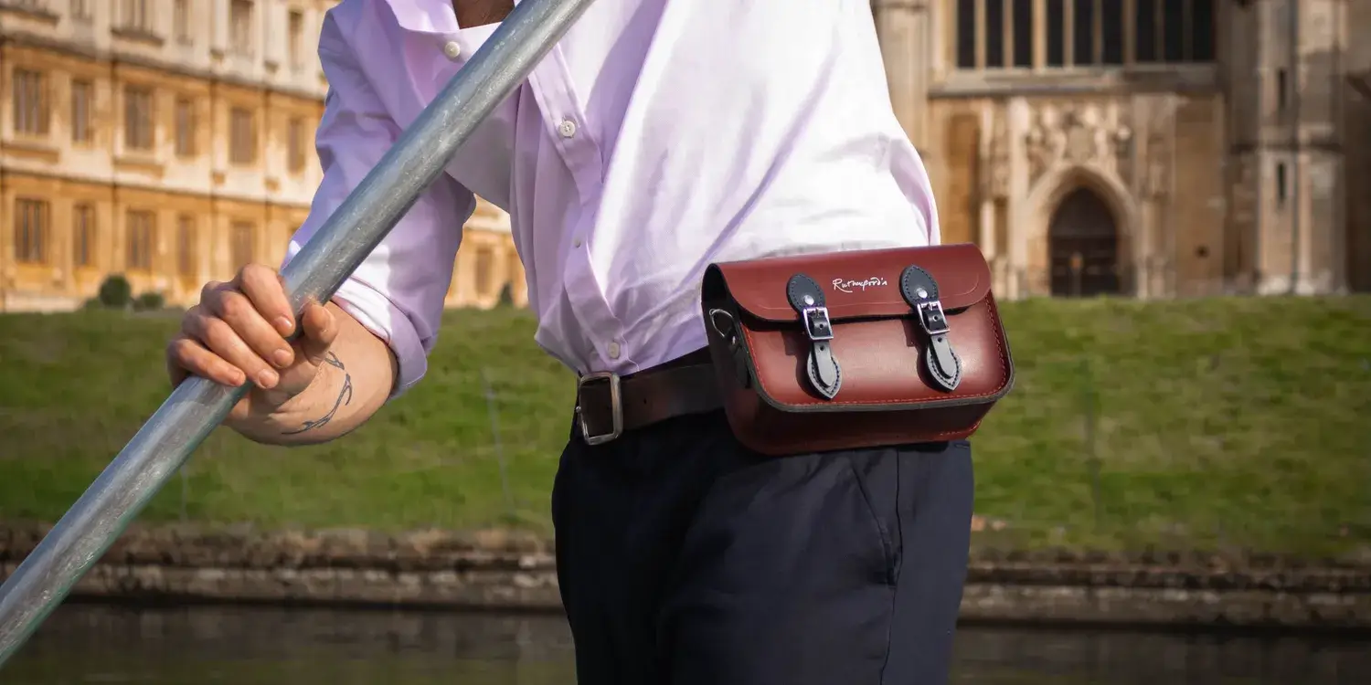 A close-up of a punting guides leather satchel, attached to their belt.