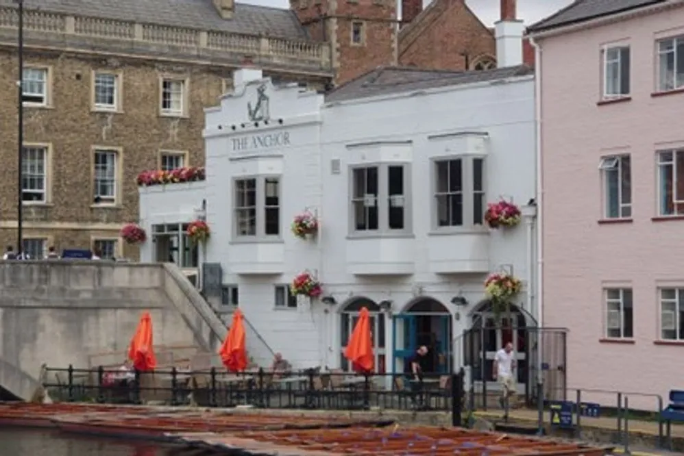 The Anchor pub, a white building on the riverfront.