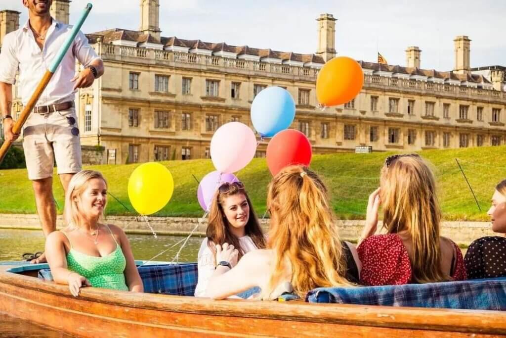 A hen do in a punt in Cambridge with balloons